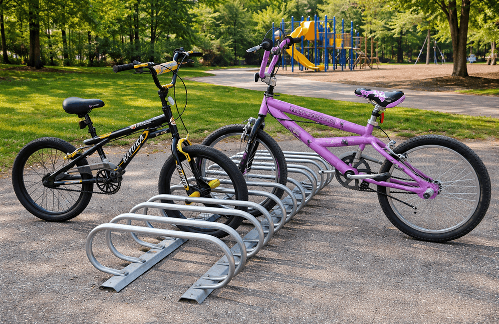Low profile bike rack near playground with children’s bikes parked demonstrating accessible bike parking for community and recreational spaces